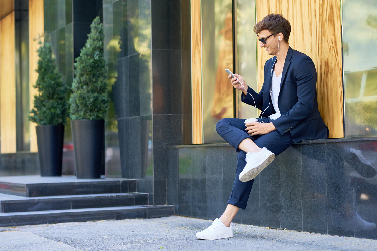 trendy young man relaxing with smartphone