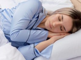 young beautiful woman blue pajamas laying bed 2 800x450