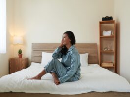 woman in pajama sitting on bed