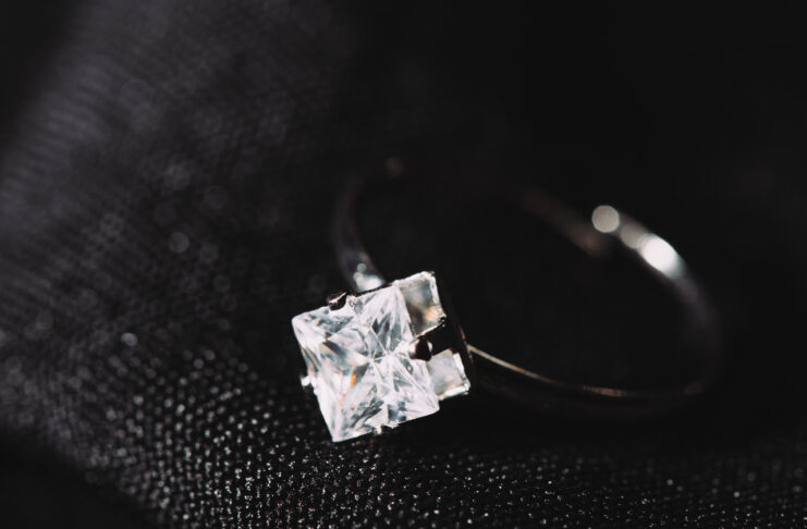 engagement ring with pure sparkling diamond on black cloth